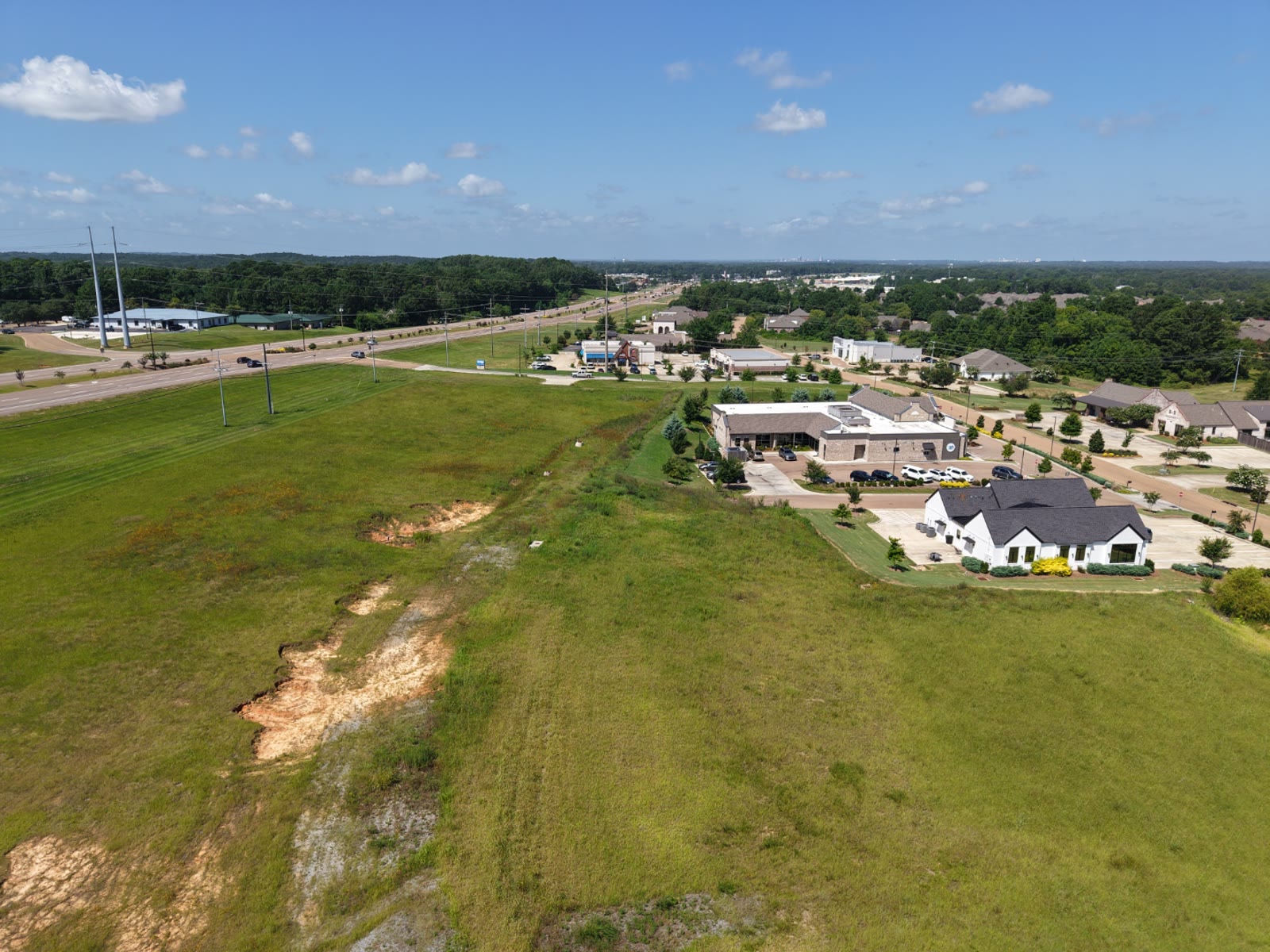 Aerial view of a graded commercial development site with cleared land ready for construction in Central Mississippi