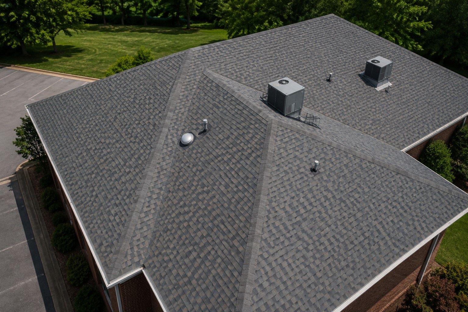 Close aerial view of an asphalt shingle roof showing vents and HVAC units, illustrating the level of detail captured for roof inspections