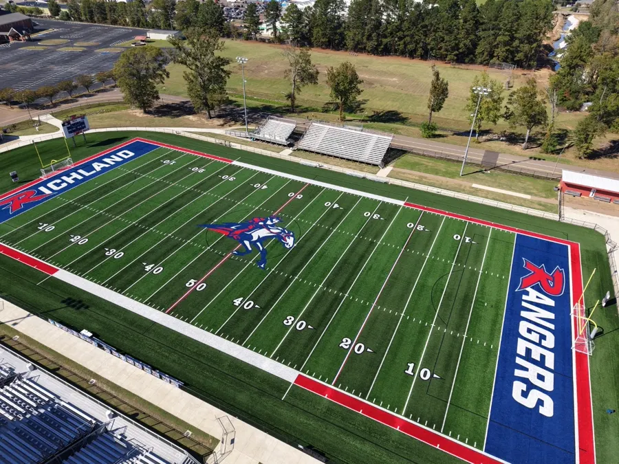 High-resolution aerial view of a football field turf and stadium