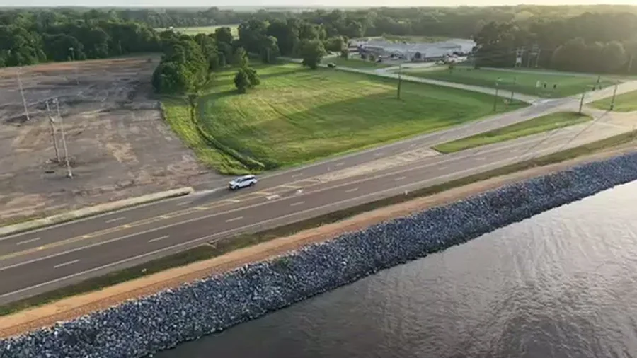 Aerial view of a graded lot along a roadway near a waterway