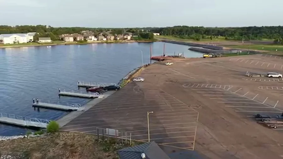 Aerial view of a waterfront site under development with construction equipment
